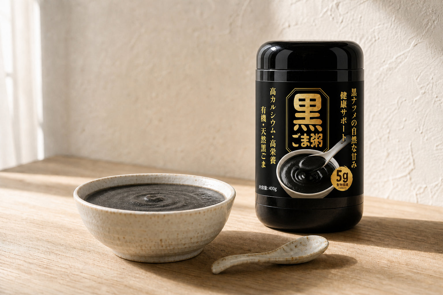 Level bowl of black sesame porridge beside its upright package in natural morning light