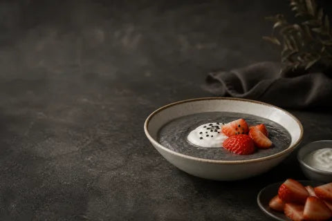 Black Sesame Porridge topped with strawberries and plain yogurt